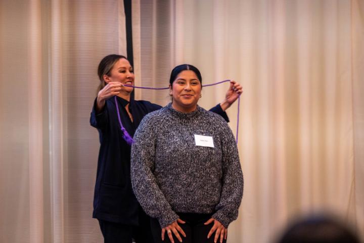 A senior Lunsford Scholar receives their graduation cord